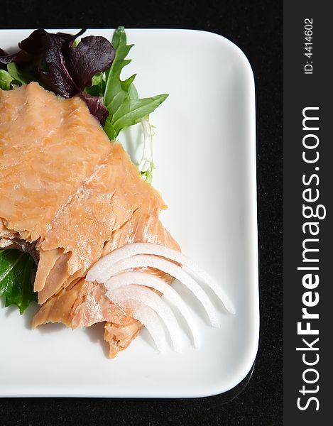 Alaskan smoked sockeye salmon starter on a bed of lettuce