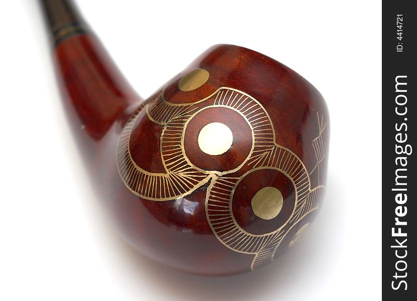 Close-up of curved ornamented north-caucasian pipe with white background