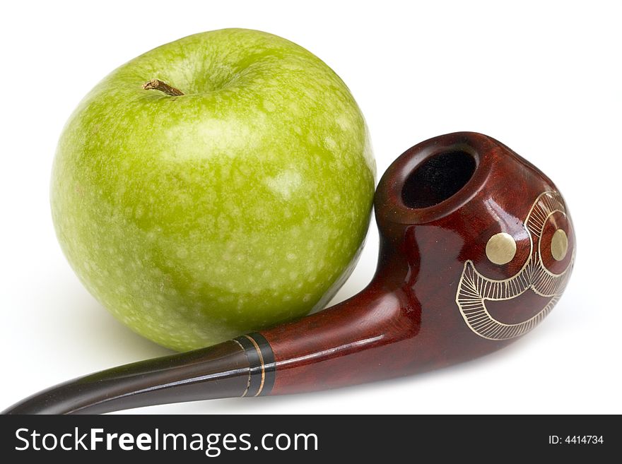 Long ornamented north-caucasian pipe with big green apple at white background. Long ornamented north-caucasian pipe with big green apple at white background