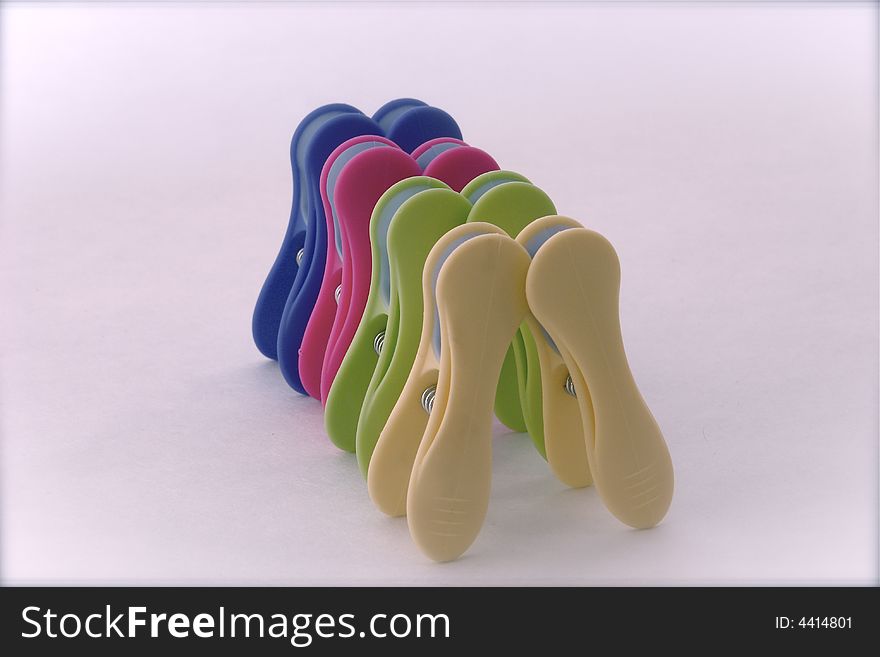 Group of clamps for hanging cloths symbolizing a queue of people