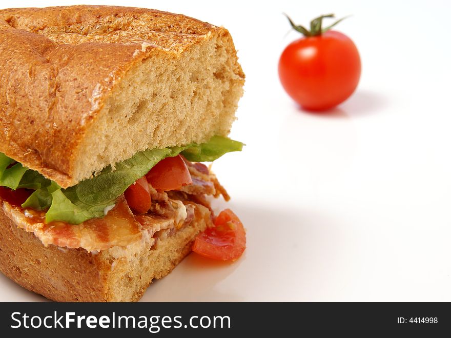 Bacon Sandwich with bacon, lettuce, tomato and mayo on whole wheat coarse bread bun