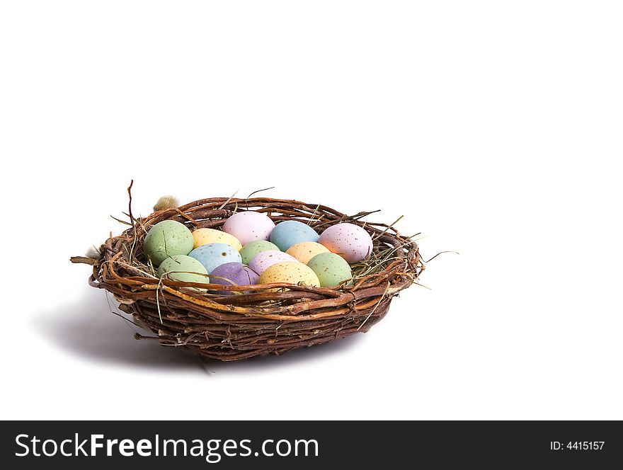 A bird nest with full of spotted eggs in it. Perfect for easter concept. Isolated on white. A bird nest with full of spotted eggs in it. Perfect for easter concept. Isolated on white