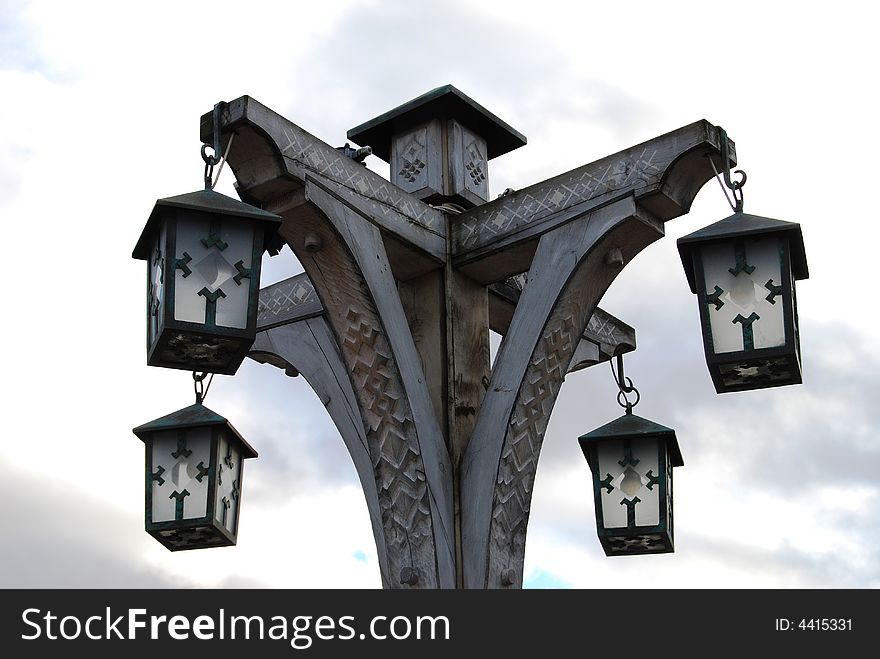 Ancient street lantern on the background of cluody sky