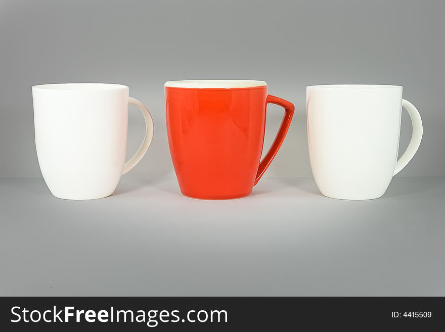 Set of three coffee mugs on graduated gray background