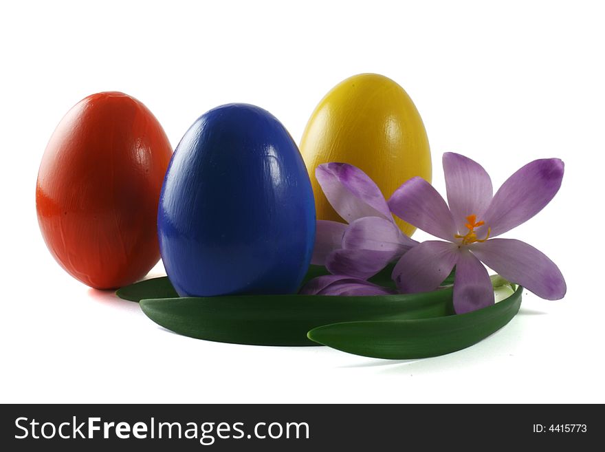 Three coloured eggs with spring flowers isolated on white. Three coloured eggs with spring flowers isolated on white