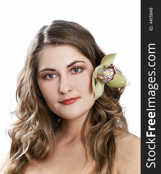 Face of a young woman with orchid at hair on white background. Face of a young woman with orchid at hair on white background