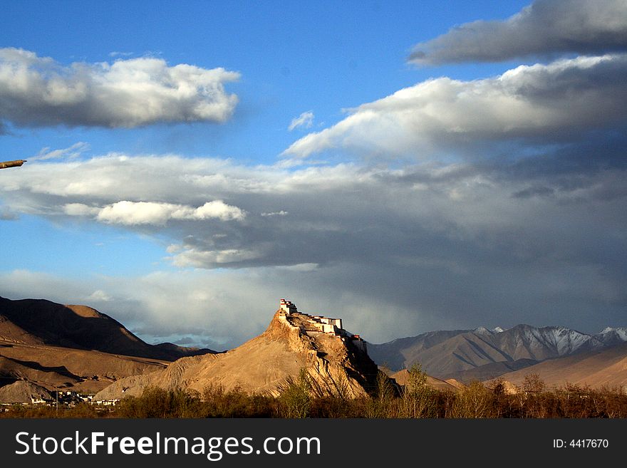 In Gyangze, an ancient tibetan castle seat on the mountain top with the sunlight. In Gyangze, an ancient tibetan castle seat on the mountain top with the sunlight