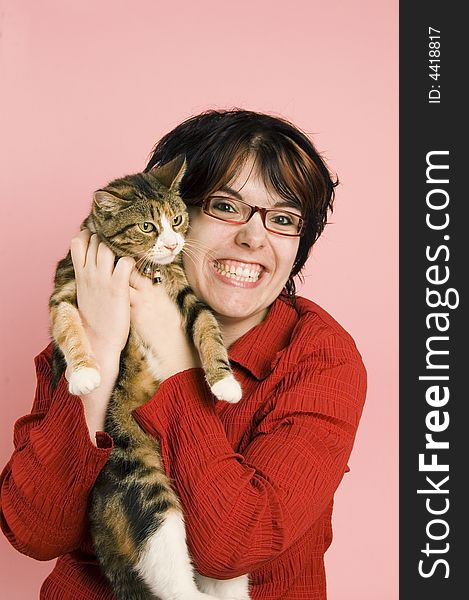 Young woman holds a domestic cat