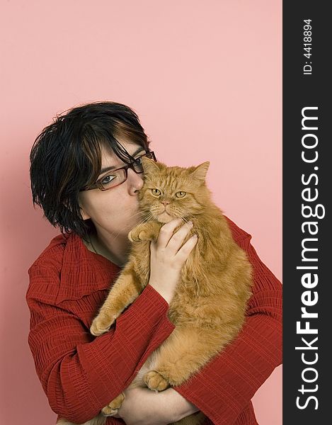 Beautiful woman holding a domestic red cat