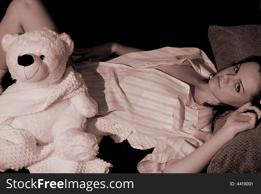 Beautiful girl with a toy bear. Sepia