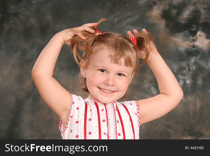 Child keeps hairs and smiles