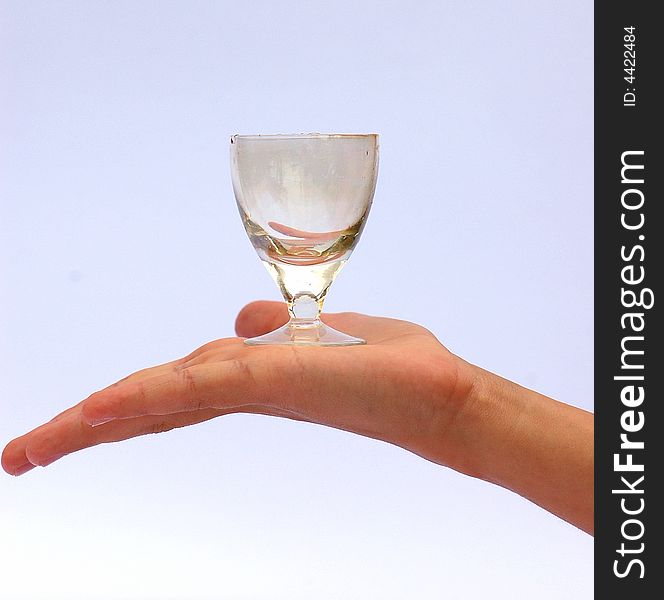 Womans hand , holding old empty vodka glass. Womans hand , holding old empty vodka glass