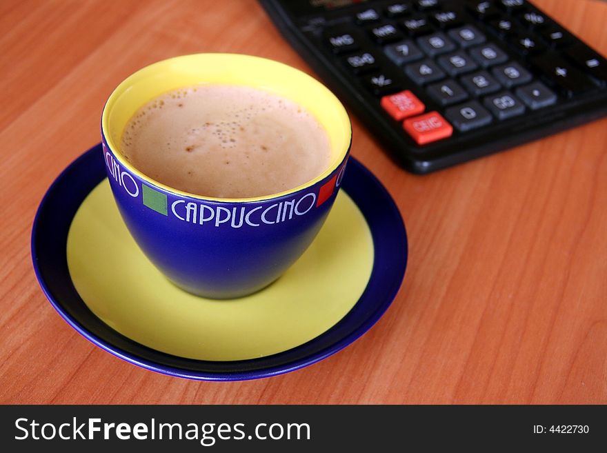 A cup of capuccino on brouwn background. A cup of capuccino on brouwn background.