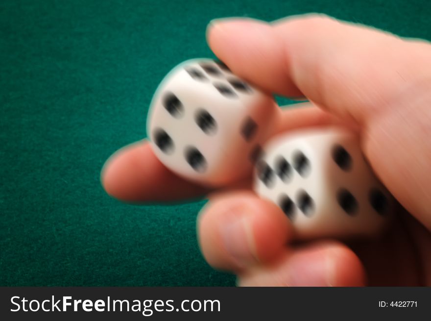 Hand rolling dice on green carpet. Hand rolling dice on green carpet