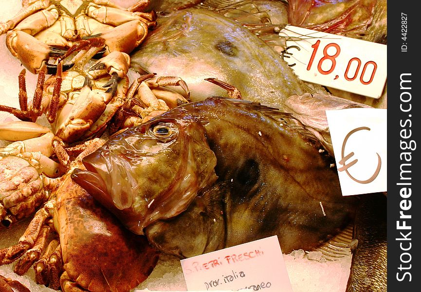 Fish and crabs on counters of the Venetian market