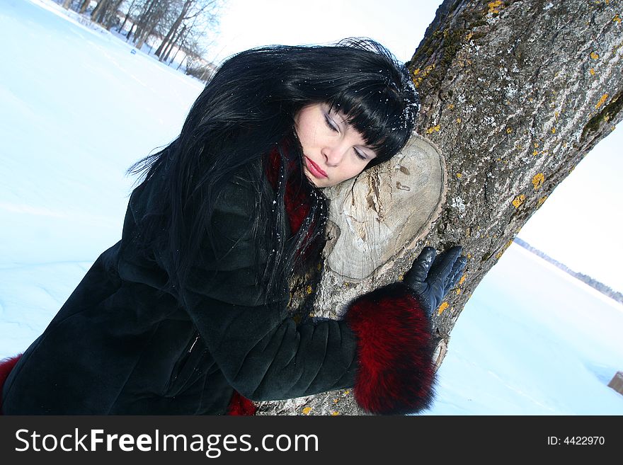 Woman near tree.