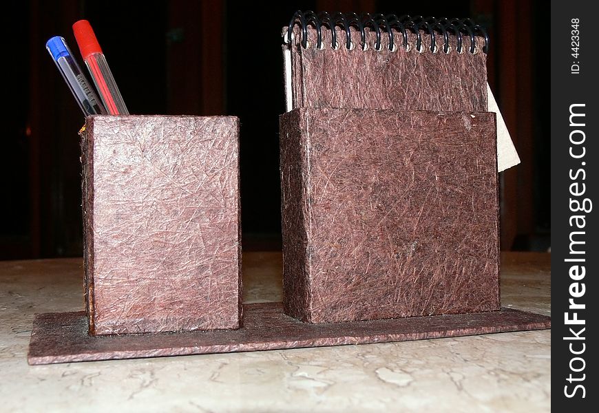 Notebook and pen holder made with recycled paper