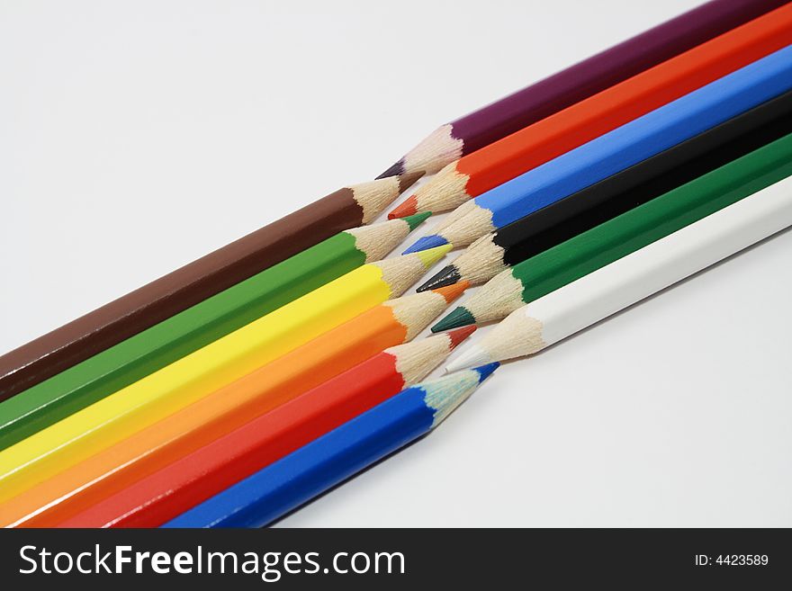 Lot of coloured pencils on white background