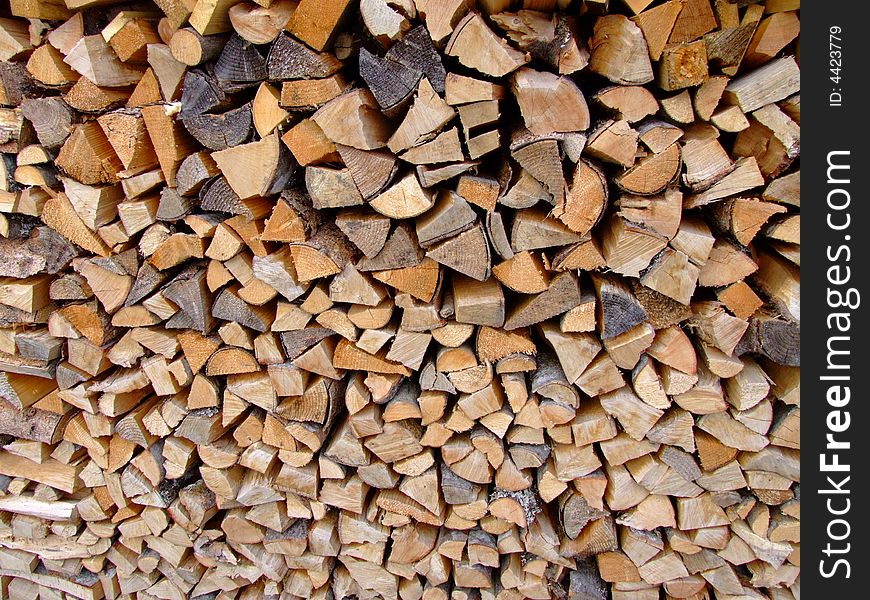 Pile of chopped fire wood (background)