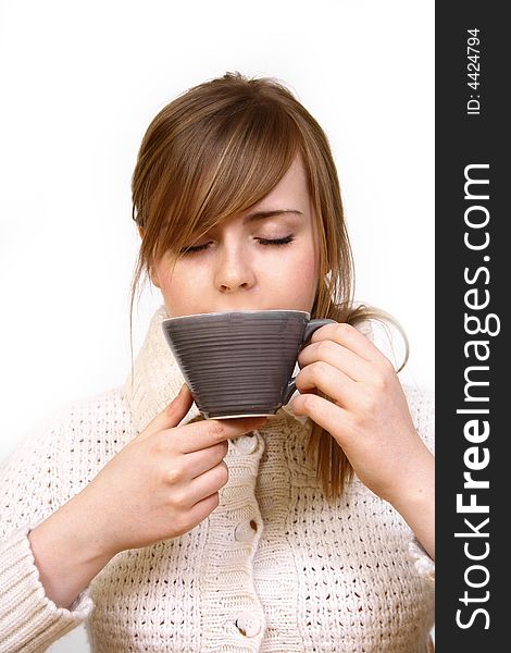 A beautiful young woman holding a cup of hot drink