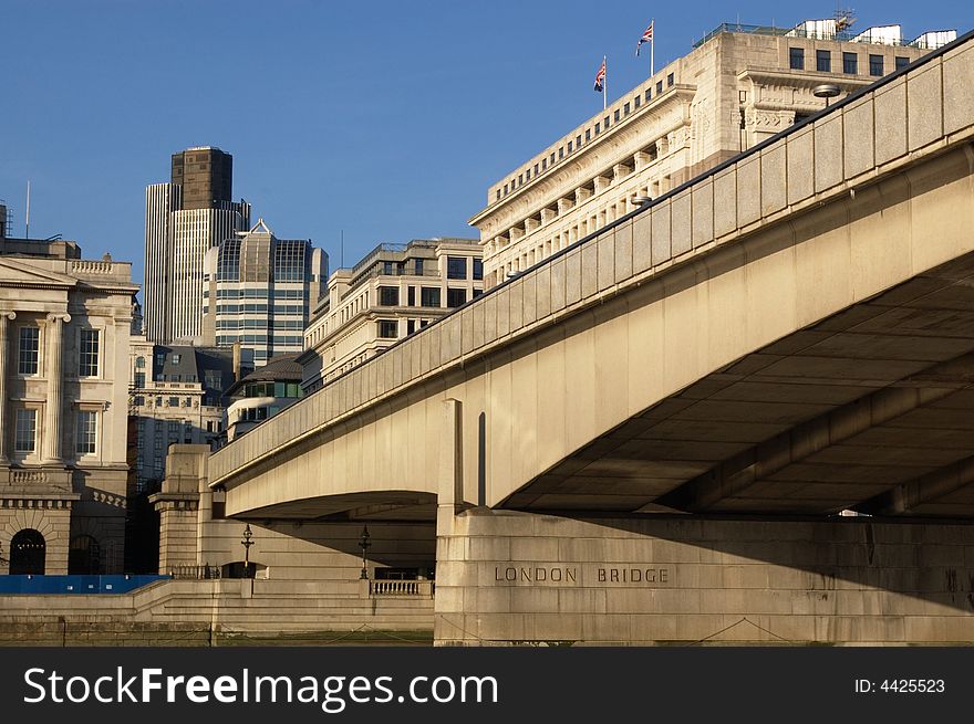 Modern buildings in and London bridge, view from water.  Horizontal. London, UK. Modern buildings in and London bridge, view from water.  Horizontal. London, UK.