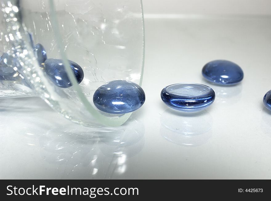 Round blue stones from a glass dish. Round blue stones from a glass dish