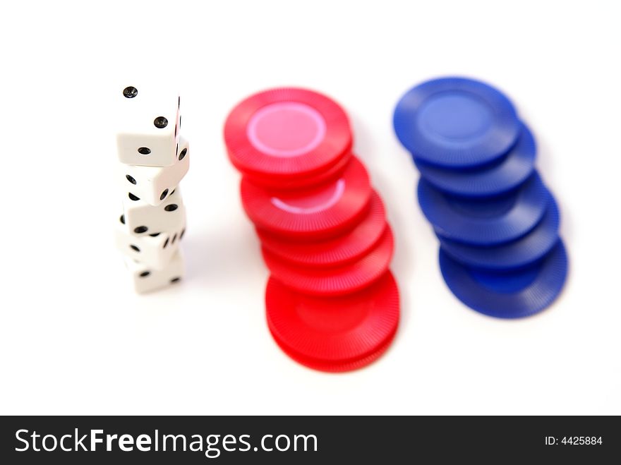 Multiple white dice with red and blue poker or game chips. Very low depth. Multiple white dice with red and blue poker or game chips. Very low depth.