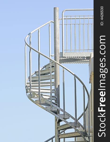 A Spiral metal staircase leading upwards to a gantry at a winery in Napa valley. A Spiral metal staircase leading upwards to a gantry at a winery in Napa valley