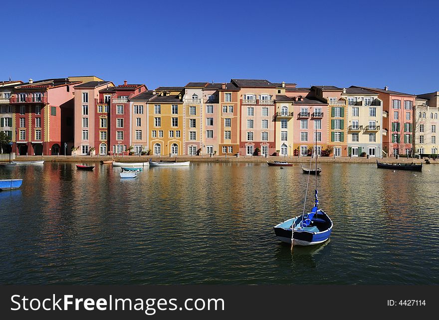 Photo of a Lake with fishing boats and Tuscany Style Buildings in Background. Photo of a Lake with fishing boats and Tuscany Style Buildings in Background