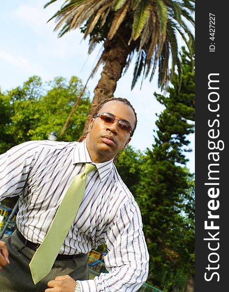 Businessman Flexing for the camera. Palm trees in the background. Businessman Flexing for the camera. Palm trees in the background.