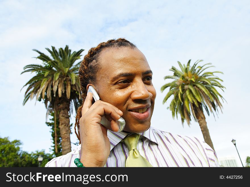 Businessman talking on the phone and smiling. . Businessman talking on the phone and smiling.