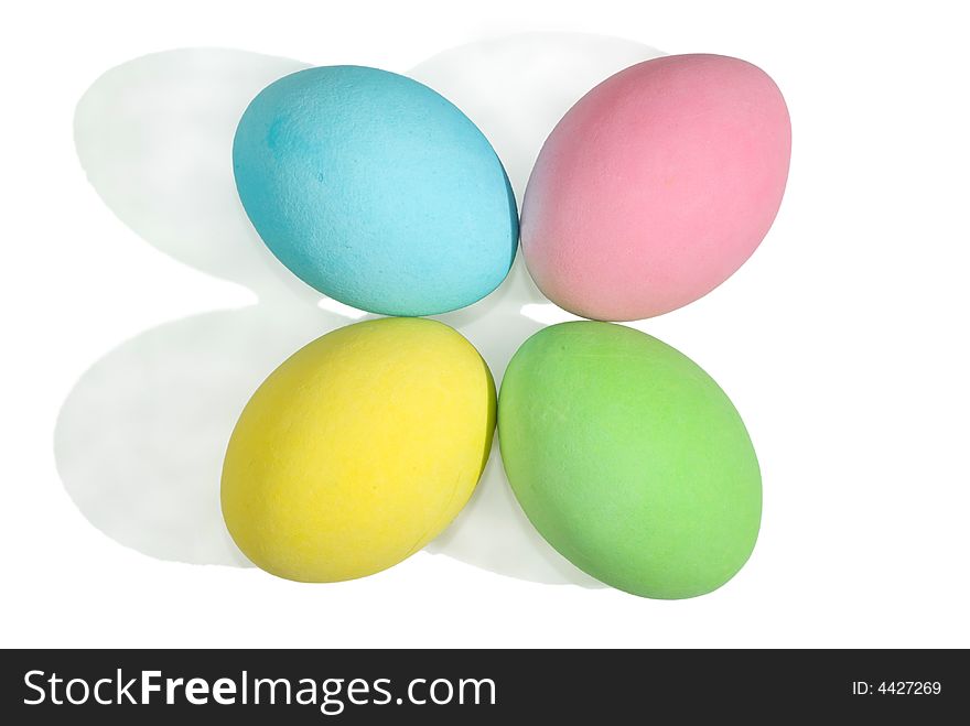 Closeup of a 4 colored easter eggs isolated in white background.
