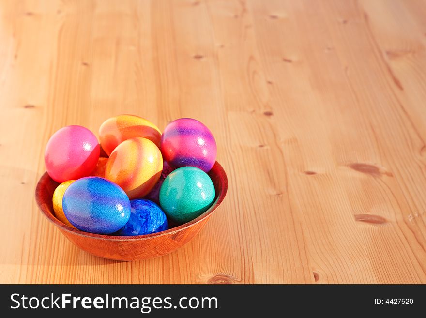 Easter eggs in the cup on a wooden table. Easter eggs in the cup on a wooden table.
