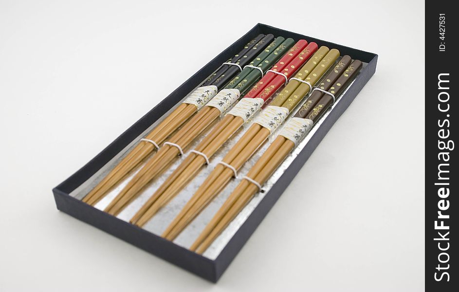 Five Pairs of Chopsticks in a Box on white background