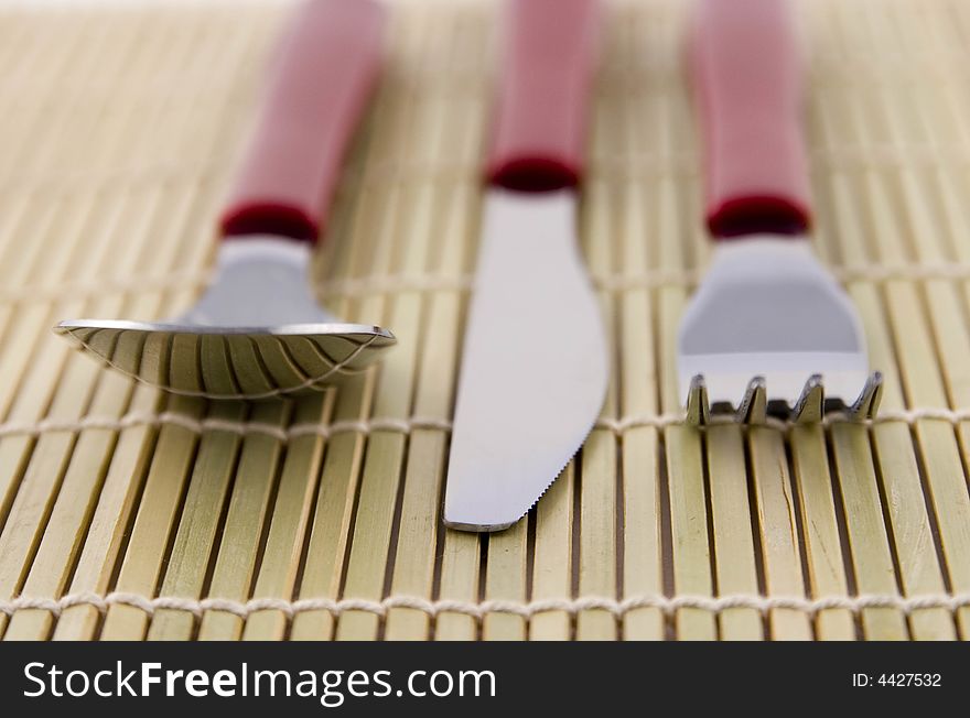 Dinner Utensils on Wooden Placemat. Dinner Utensils on Wooden Placemat