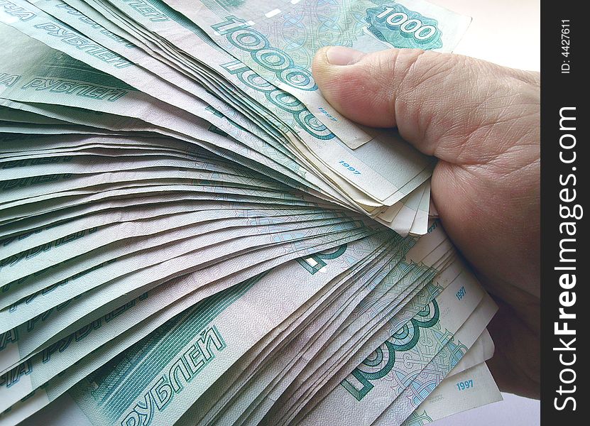 The hands, holding many of the Russian banknotes