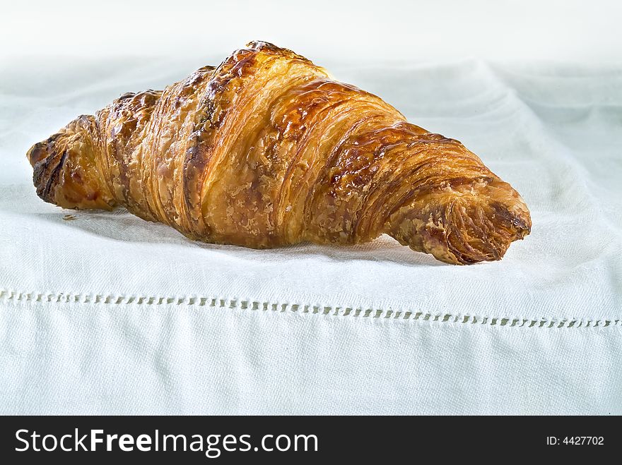 Plain croissant on white table cloth