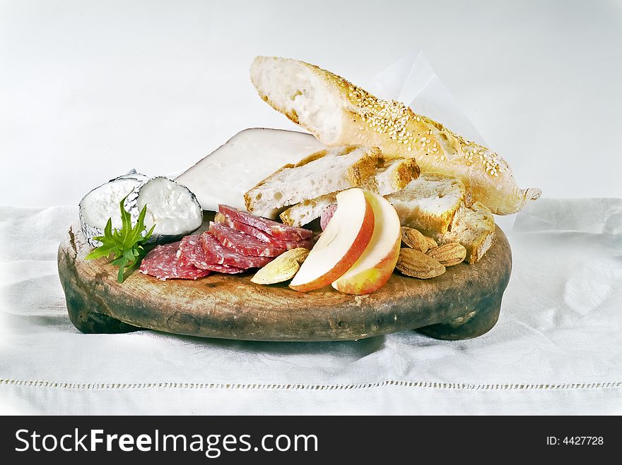 Wine cheese bread and fruits on white