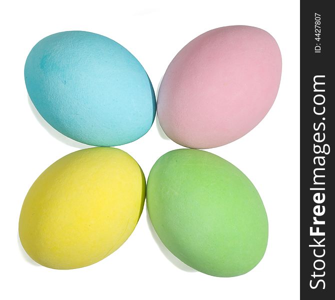 Closeup of a 4 colored easter eggs isolated in white background. Little shadow.