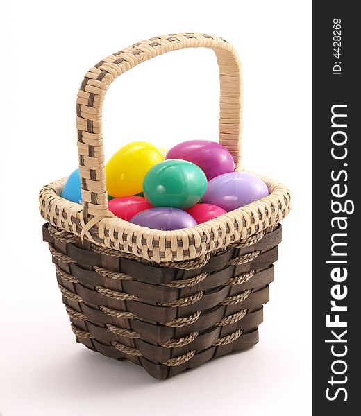 Wicker Easter Basket full of colorful eggs. Wicker Easter Basket full of colorful eggs