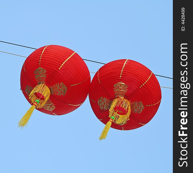 Two paper lanterns hanging outside to celebrate the Chinese New Year. Two paper lanterns hanging outside to celebrate the Chinese New Year