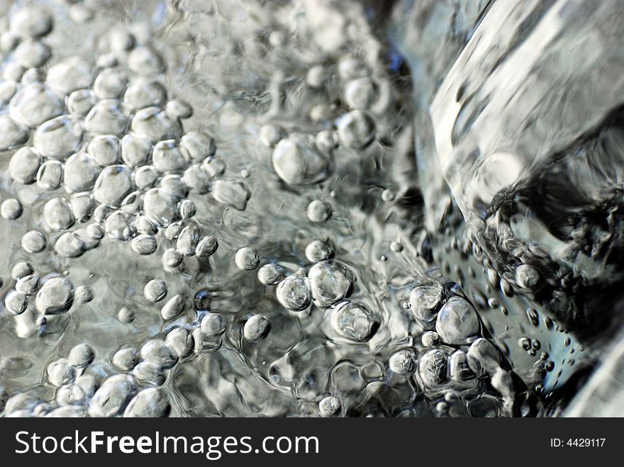 Water bubbles on waterfall through canal