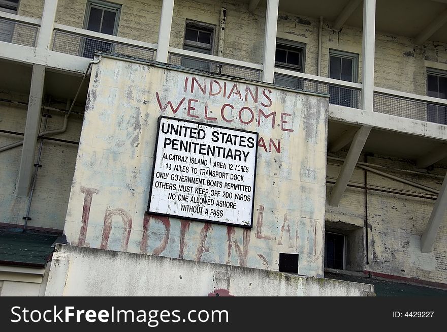 Old and decayed Alcatraz jail sign. Note graffiti painted on walls from the days of occupation by the American Indian Movement in the 1970s. Old and decayed Alcatraz jail sign. Note graffiti painted on walls from the days of occupation by the American Indian Movement in the 1970s.