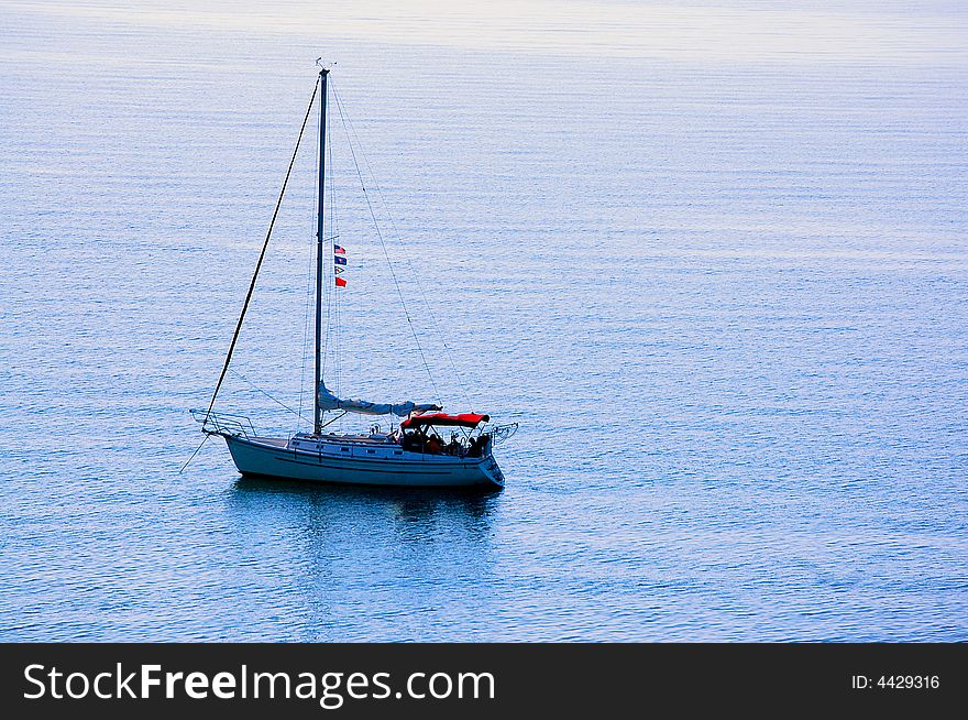 Sailing yacht anchored off lake michigan coast.