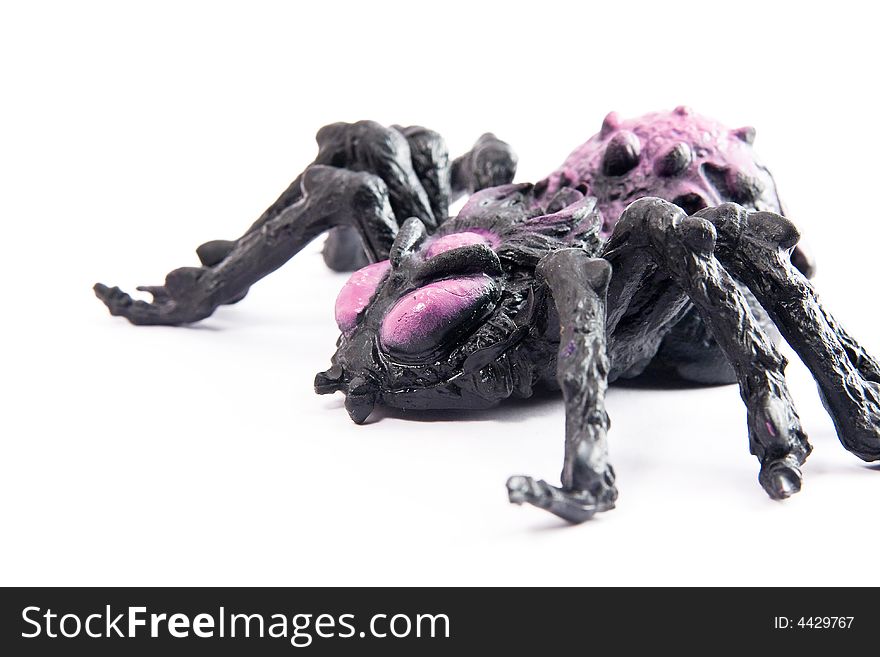Single black toy spider white background macro