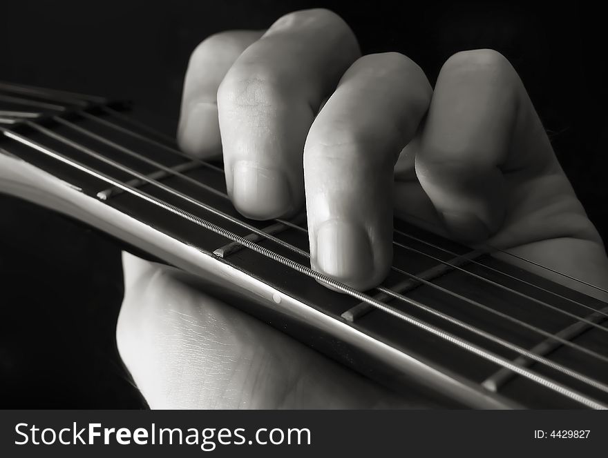 Hand forming chord on guitar. Hand forming chord on guitar