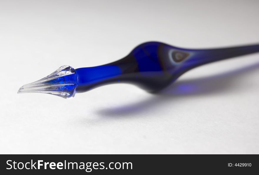 Antique blue glass pen on white background. Antique blue glass pen on white background