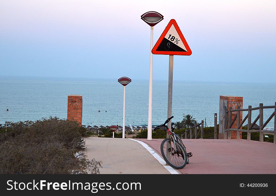 Bike parked above A Calm Sea