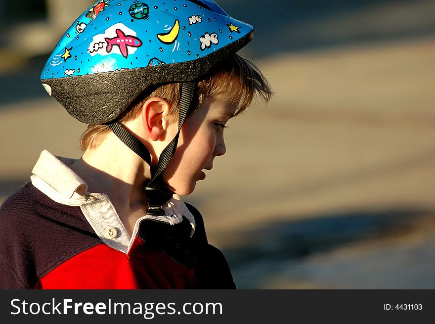 Close-up profile of boy with helmet. Close-up profile of boy with helmet