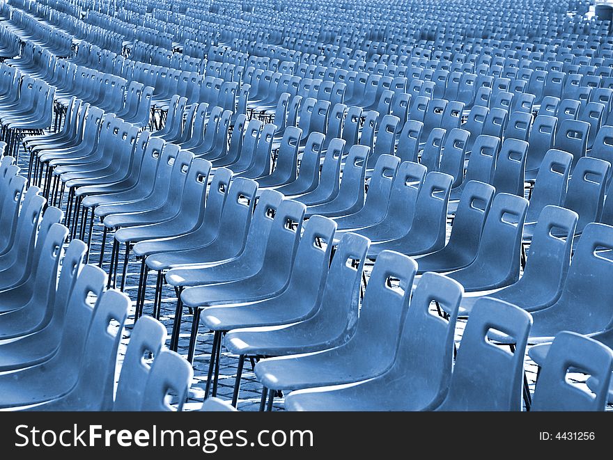 Rows of empty seats, lots of chairs. Rows of empty seats, lots of chairs